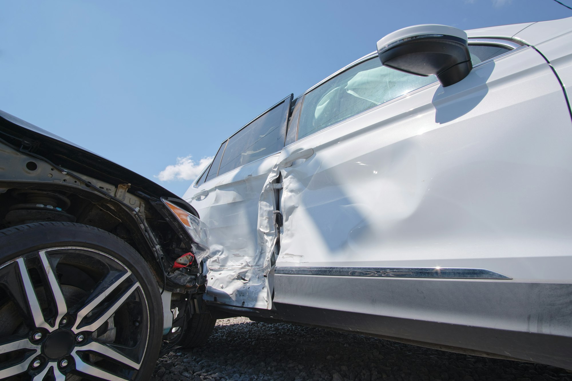 Cars crashed heavily in road accident after collision on city street.